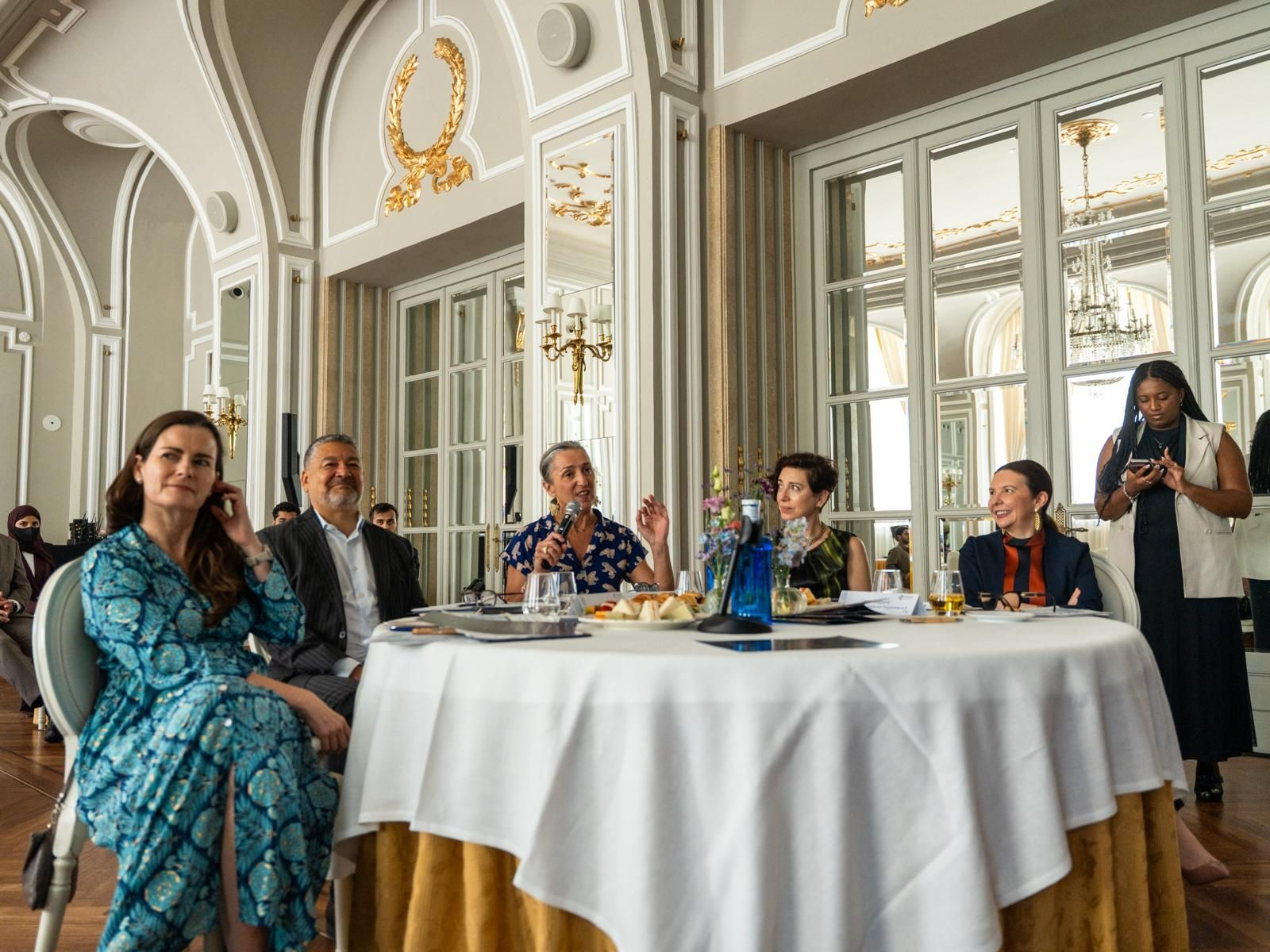 A SALUZ Institute Performance Lab in session, faculty and executives seated around a table